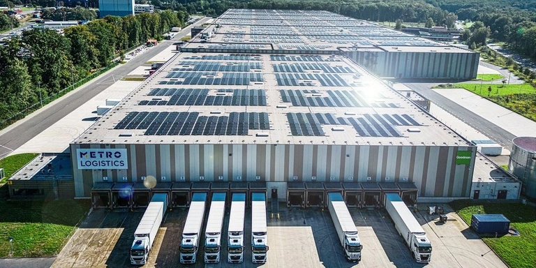 Large commercial logistics warehouse roof covered in JA Solar panels