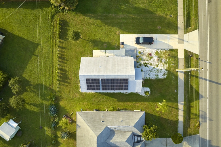 Aerial view of a home rooftop fitted with JA Solar panels